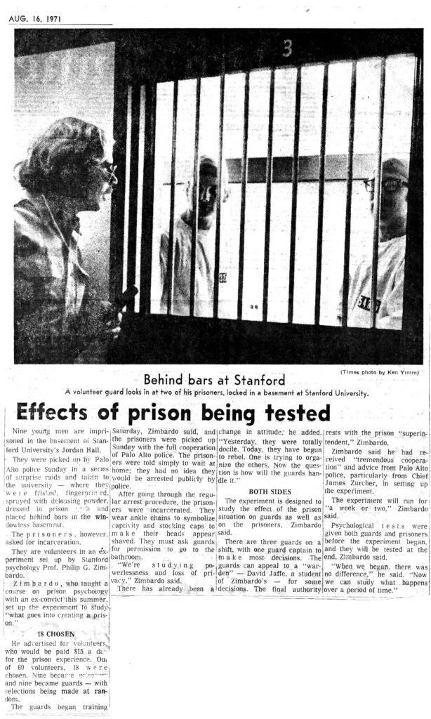 Newspaper article titled "Effects of prison being tested" that features a guard looking through cell door bars at two prisoners.