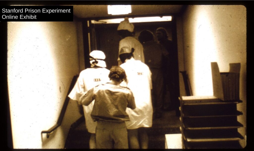 Rich and other prisoners being led away from the "prison"